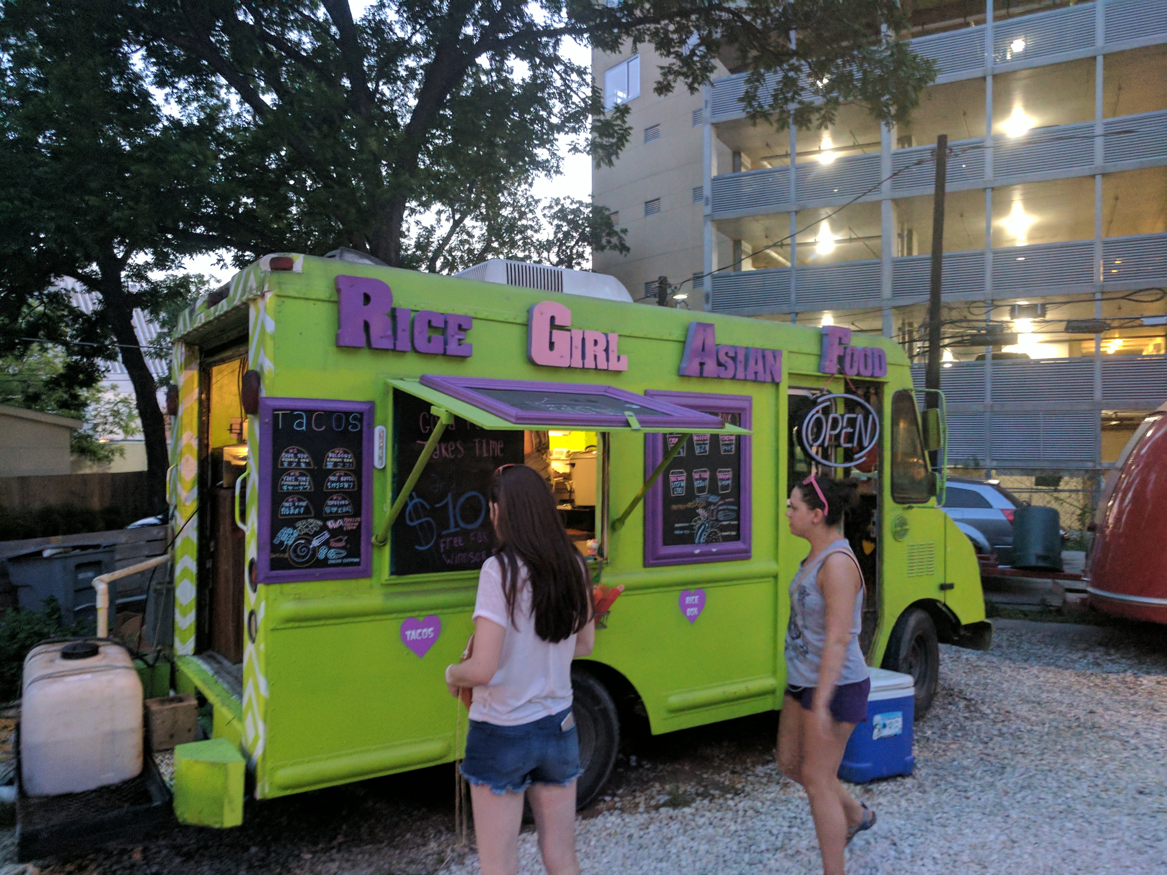 Food truck serving customers outside a business building